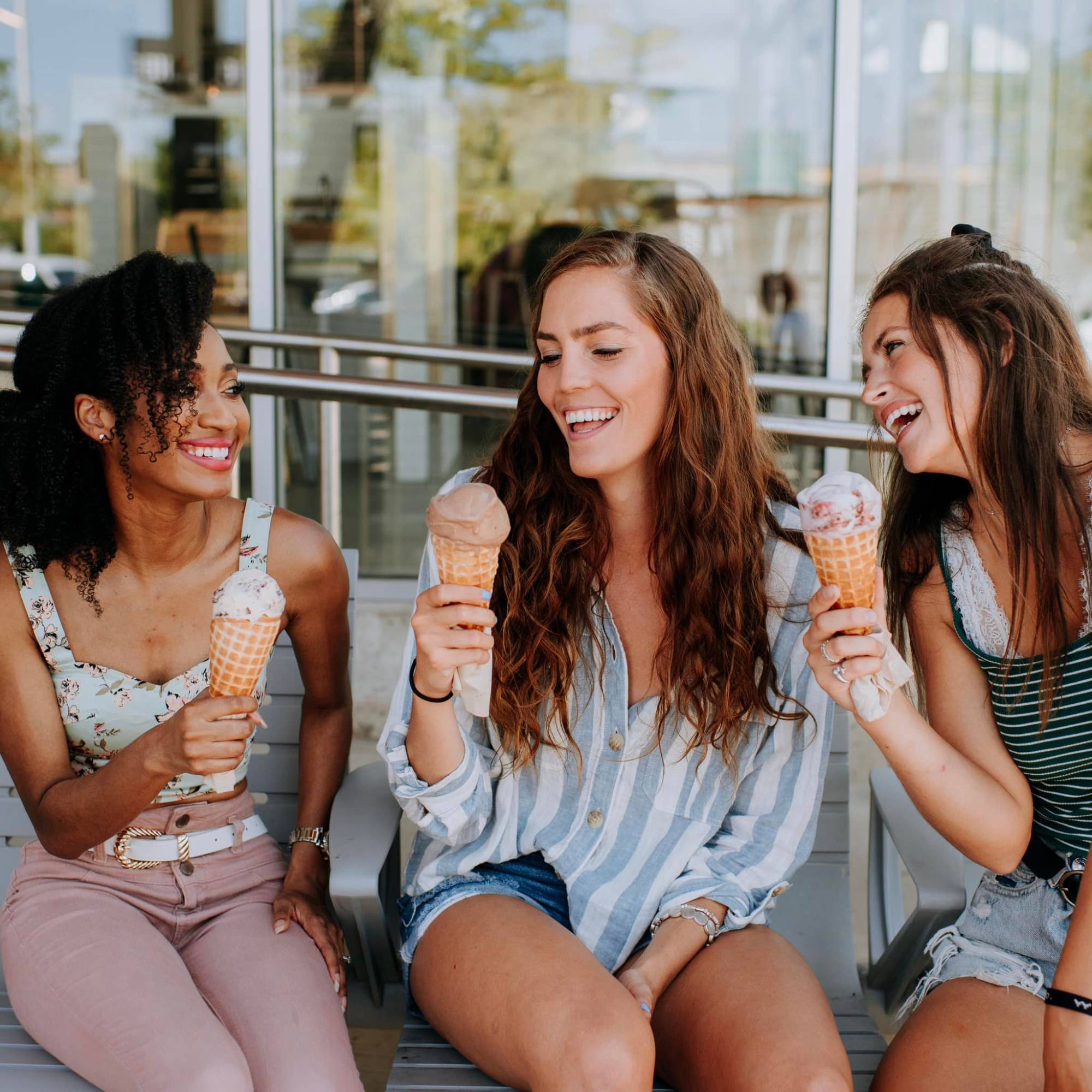 Three friends smile while enjoying Love's Ice Cream